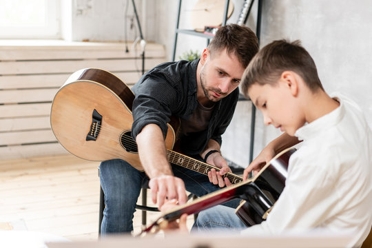 teacher and student with
guitars